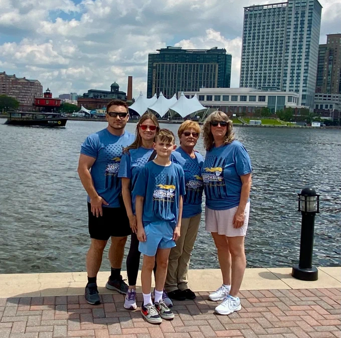 U.S. Marshals Service staff pose in front of the Baltimore Inner Harbor. 