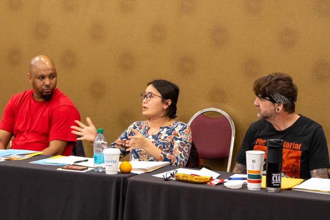 One woman speaks while two other members listen
