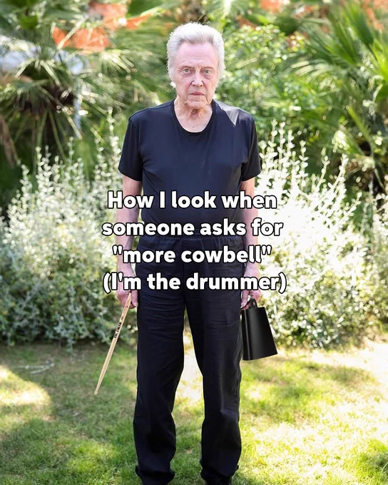 Christopher Walken standing in a garden holding a cowbell, with a humorous caption about being asked for "more cowbell.