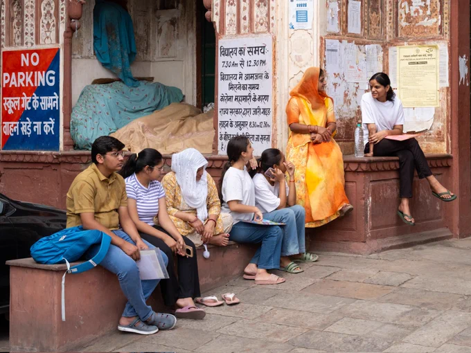 Shot by Shashwat Nagpal. https://www.shashwat.in. 
Picture of students and a parent waiting outside their school for final examination results, Jaipur, Rajasthan, India.