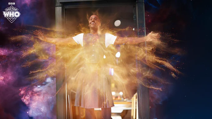 The Doctor (Ncuti Gatwa) stands in the doorway of the TARDIS in space as regeneration energy begins to emit from him in 'The Reality War'.