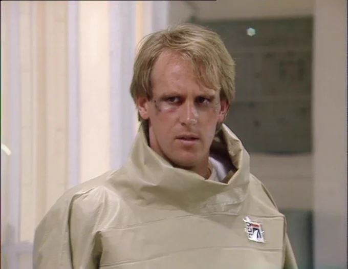 A bruised and battered Peter Davison glowers after his ordeal, convinced that there should have been another way.
