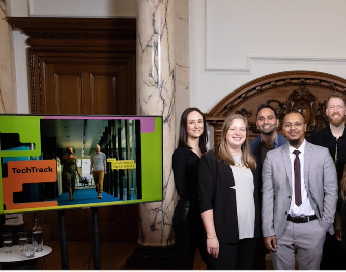 Our apprentices photographed together next to a TechTrack screen. 