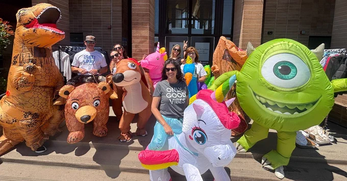 John McCandless staff members pose for a photo in front of the school while wearing balloon animal costumes.