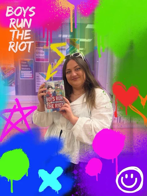 Woman holds a book with brightly coloured graffiti style paint superimposed around the image.