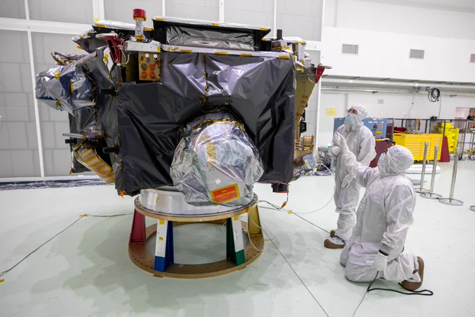 Technicians remove protective coverings form NASA’s IMAP (Interstellar Mapping and Acceleration Probe) inside the high bay at the Astrotech Space Operations Facility near the agency’s Kennedy Space Center in Florida on Thursday, May 29,2025. 