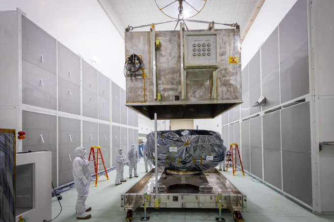 Technicians remove NASA’s IMAP (Interstellar Mapping and Acceleration Probe) spacecraft from its shipping container inside the high bay at the Astrotech Space Operations Facility near the agency’s Kennedy Space Center in Florida on Thursday, May 29, 2025.