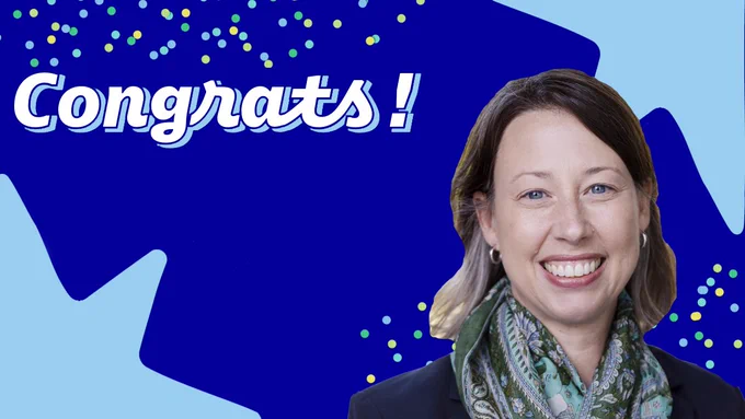 Jill Yochim smiling at camera with a decorative background that has a few polka dots and the word congrats along the top and stars in the top right and bottom left corners
