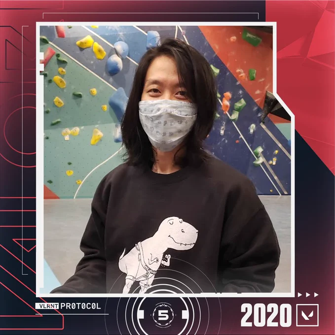 This is a carousel post featuring the before-and-after headshots of a VALORANT developer. In this 2020 headshot, you see that he has long hair and is wearing a medical mask.