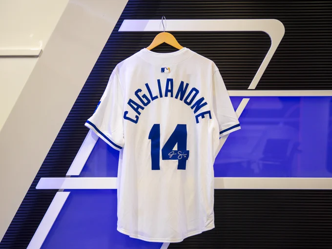 Photo of the back of a signed white and blue Jac Caglianone jersey, with the autograph on the 4