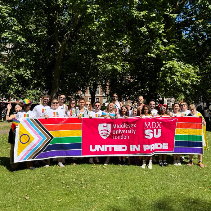 Large group of people in front of a banner that says 'Middlesex University London' 'MDXSU' 'United in Pride'