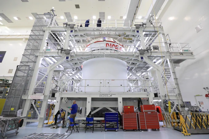Technicians with NASA’s Exploration Ground Systems offload the agency’s Orion spacecraft from the KAMAG transporter to the servicing stand inside the Multi-Payload Processing Facility at Kennedy Space Center in Florida on Sunday, May 4, 2025, to undergo fueling and processing operations for prelaunch operations.