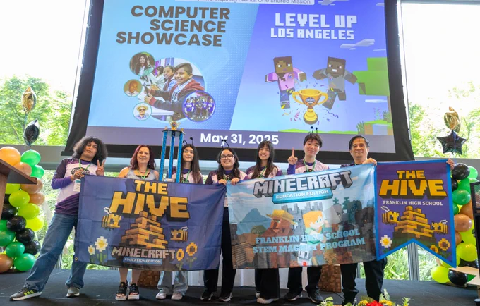 Photograph of High School Division champions wearing esports jerseys and holding up their trophy.