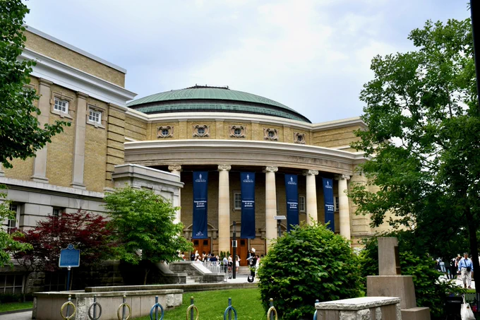 The exterior of Convocation Hall decorated with large blue banners reading 'Congratulations to all our graduates.'