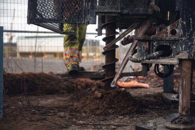 A close-up shot of a heavy drilling machine on a construction site.