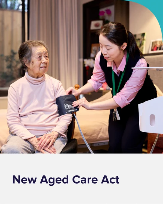A photograph of an aged care worker performing a blood pressure check on an older woman. At the bottom is a banner with text that reads, ‘New Aged Care Act’.