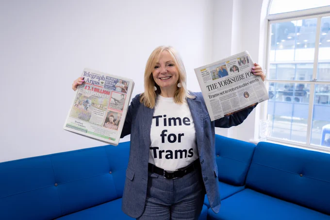 An image of Tracy Brabin, the Mayor of West Yorkshire holding up The Yorkshire Post and the Telegraph & Argus, she is smiling and wearing a t-shirt that reads: Time for Trams