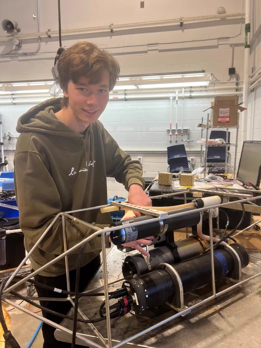 A person adjusts equipment inside Seaweed Innovation Lab.  