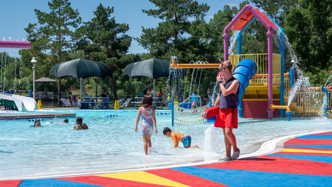 A lifeguard keeping watch over children swimming at the City Park Pool