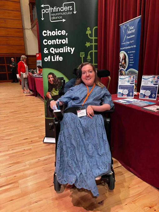 Suzanne Glover in front of a Pathfinders banner