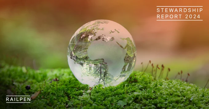 Glass world ornament on patch of grass.