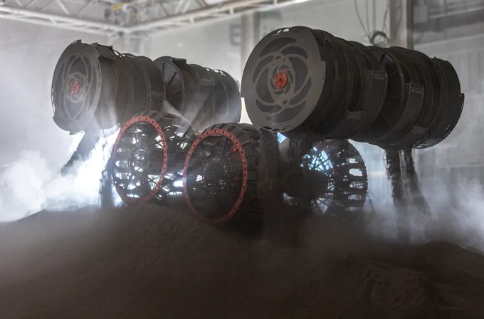 NASA’s RASSOR (Regolith Advanced Surface Systems Operations Robot) conducts excavation testing of simulated regolith, or lunar dust found on the Moon’s surface, inside of the Granular Mechanics and Regolith Operations Lab at the agency’s Kennedy Space Center in Florida on Tuesday, May 27, 2025. RASSOR is designed to work in low-gravity situations, using counter rotating bucket drums on each arm to collect and dump regolith for the extraction of hydrogen, oxygen, or water, resources critical for sustaining a habitable presence. Photo credit: NASA/Frank Michaux