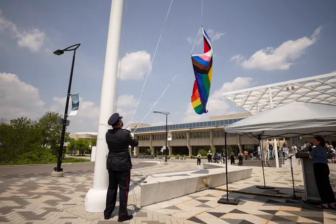 The flag is raised at U of T Mississauga outside of the Davis Building 