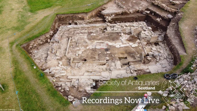 Aerial photo of a huge excavated trench showing the stone foundations of a prehistoric structure