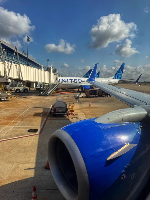 Photo of our United 737-900 engine with another United 737 off to the side. Engine is blue.