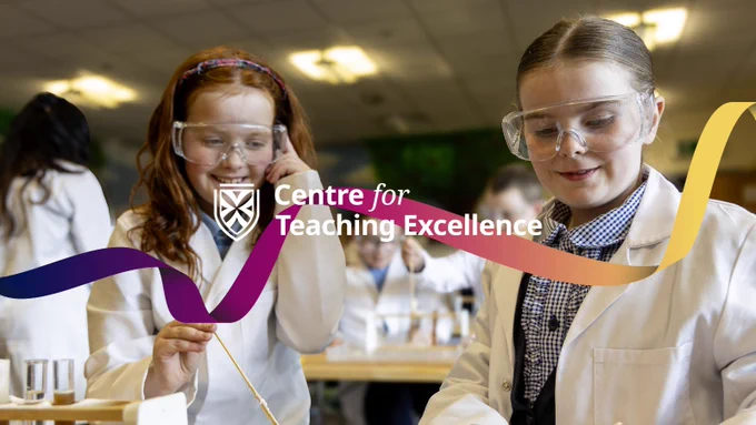 Primary school students wearing lab coars and goggles, conducting a science experiment in class