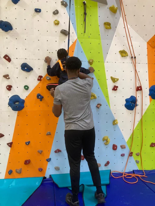 Instructor and pupil on climbing wall