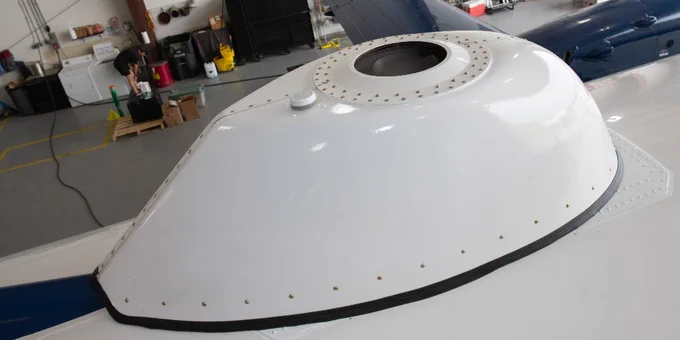 Photo of Draper's airborne CNS system mounted to the flight test aircraft with a fairing. 
