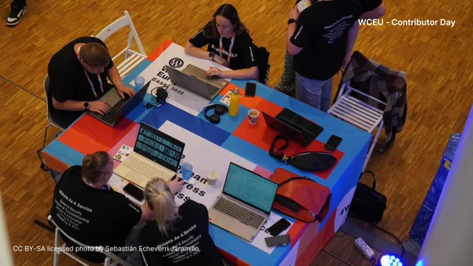 Group photo from overhead of people around a table at WCEU Contributor Day.