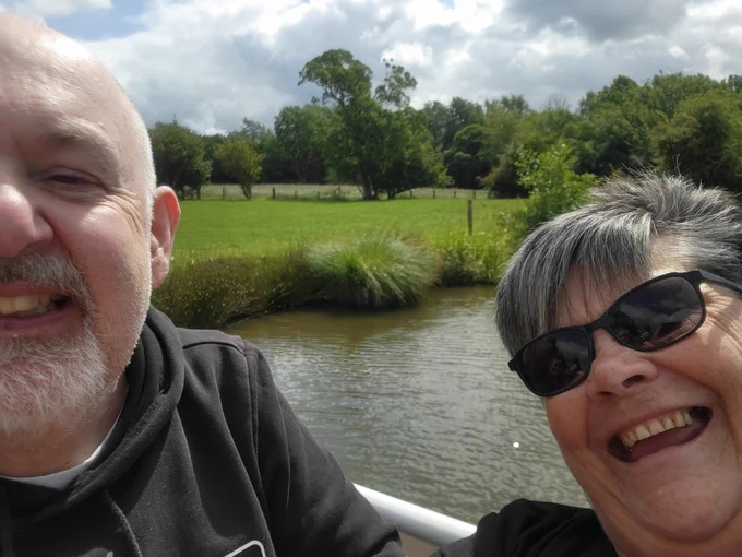 A man and woman doing a selfie on a canal boat 