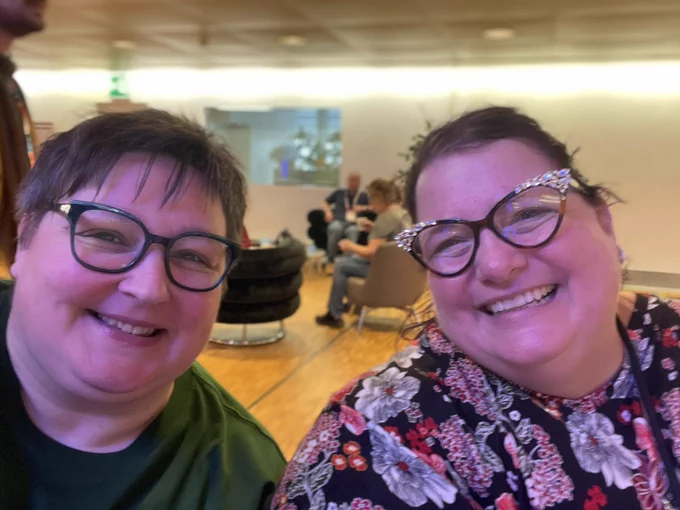 closeup photo of two middle-aged women with smiles on their faces
