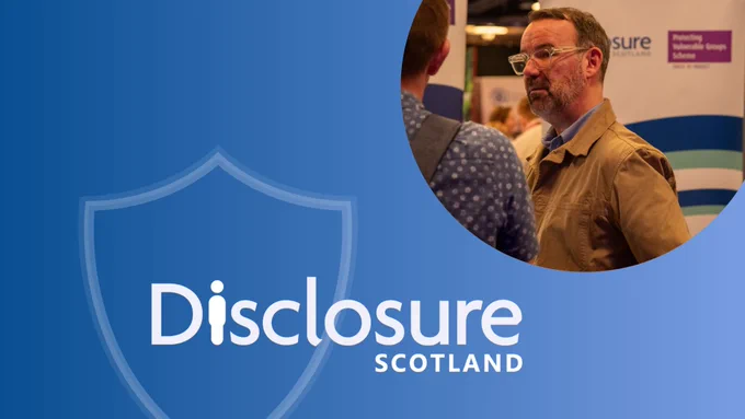 Disclosure Scotland logo and a man engaging in conversation.