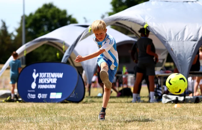a child takes a shot on goal during Great Ormond Street Hospital’s Sports Day.