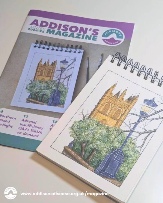 A photo of the Addison’s Disease Self-Help Group Winter 2024/25 magazine, featuring a hand-drawn illustration of a cathedral, trees, and a lamppost on the front cover. 

The drawing is also shown on a spiral-bound sketchpad next to the magazine. 

The website www.addisonsdisease.org.uk/magazine is displayed at the bottom.