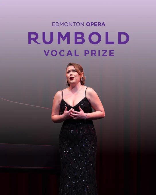 Tessa Fackelmann (Mezzo-Soprano) stands on stage mid-performance, wearing a black, floor-length gown with sparkling details. She sings with expressive emotion, hands lightly clasped near her chest. Behind her, a grand piano and red stage curtain are softly lit. The words “Edmonton Opera – Rumbold Vocal Prize” appear above her in bold purple text on a gradient lavender background.