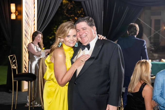 Governor Pritzker and the First Lady pose for a photo.