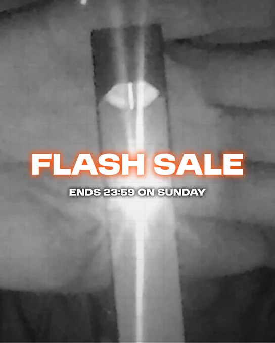 A black and white closeup image of a glowing LED light-up vape being held to the camera by an unseen person (as their hand and vape is blocking their face). There is white text with an orange glow around it in the centre of the image that says: FLASH SALE. Then smaller text below it says 'Ends 23:59 on Sunday'.