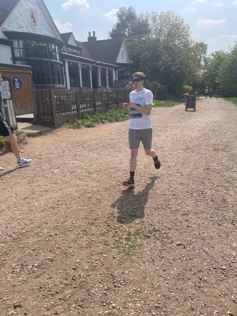 Georgia, a Share student, running along a path during a marathon.
