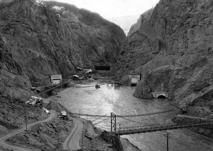 Photograph from Volume Two of a series of photo albums documenting the construction of Hoover Dam, Boulder City, Nevada. NARA's Rocky Mountain Region (Denver) (NRGA), Building 48, Denver Federal Center, West 6th Avenue and Kipling Street, Denver, CO, 80225-0307.
https://www.atlasofplaces.com/architecture/hoover-dam/ 14.8.20
INFO
https://commons.wikimedia.org/wiki/File:Looking_upstream_toward_Boulder_dam_site_showing_outlet_portals_of_all_four_diversion_tunnels._Flow_of_Colorado..._-_NARA_-_293890.jpg
