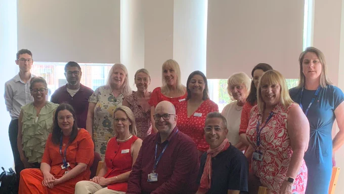 A group of people wearing red clothing to mark #RedforResearch