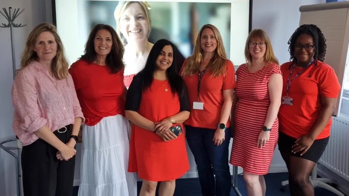 A group of people wearing red clothing to mark #RedforResearch