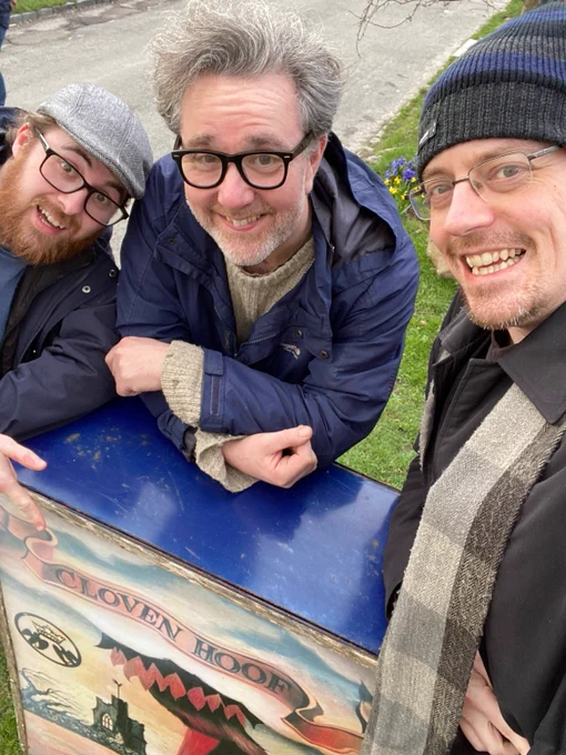 The Mulgrave Audio team with a pub sign for the 'Cloven Hoof' inn, a fictional Doctor Who pub in the real-life village of Aldbourne, location for the 1971 story The Daemons. 