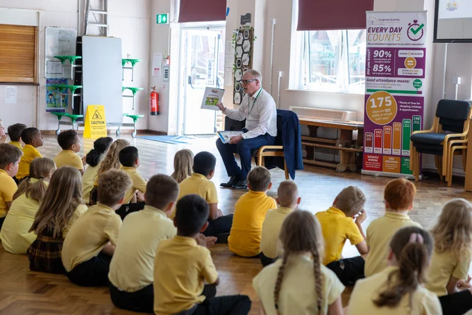 A photo of Richard Parker reading a book to pupils at Corngreaves Academy in Cradley Heath on Clean Air Day.