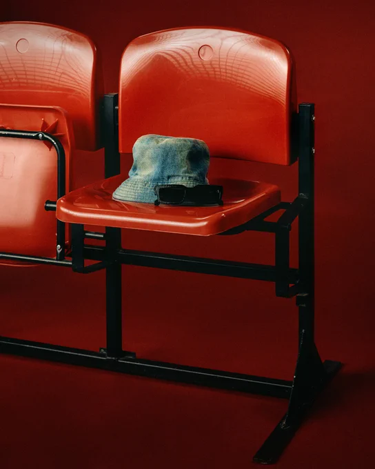 Imagery of a bucket hat and sunglasses on a chair...