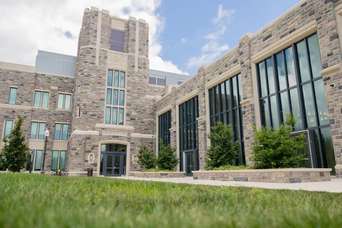 Virginia Tech Decision and Data Sciences (DDS) building stands tall in the summer light.
