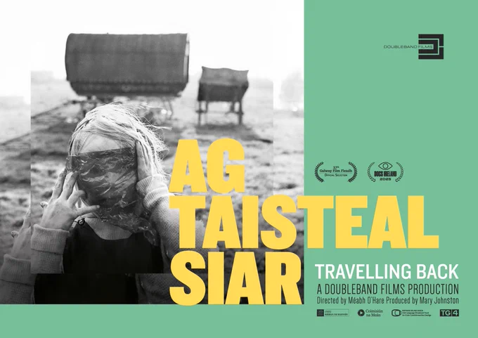 Promotional poster for the film 'Ag Taisteal Siar' Travelling Back by DoubleBand Films. Features a blurred photograph of an individual in the foreground covering their face with a piece of cloth, set against a rural landscape with a traditional caravan in the background. 